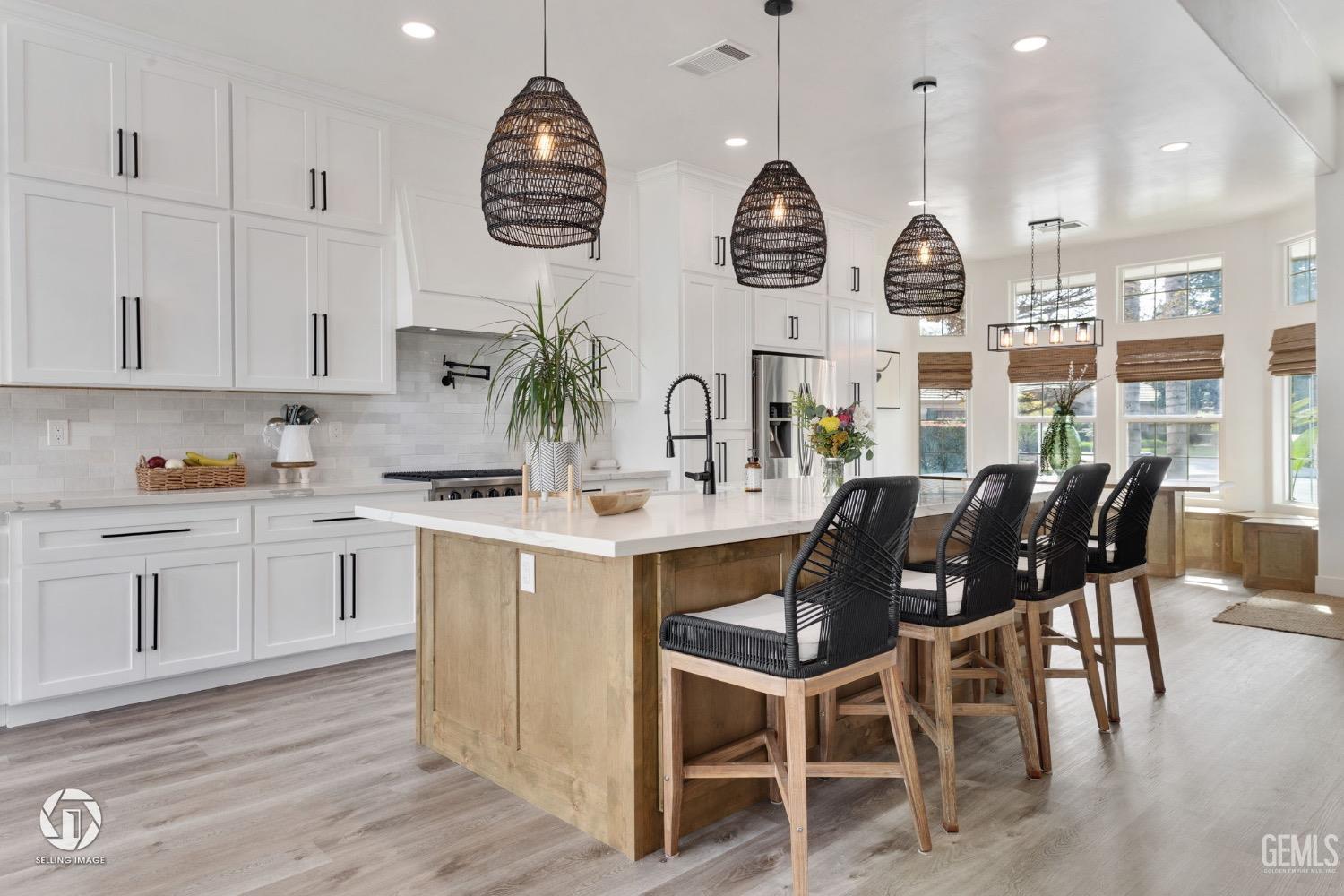 Undisclosed Address Bakersfield, CA 93314 - Photo 20 of 45 a kitchen with stainless steel appliances kitchen island granite countertop a table chairs sink and cabinets