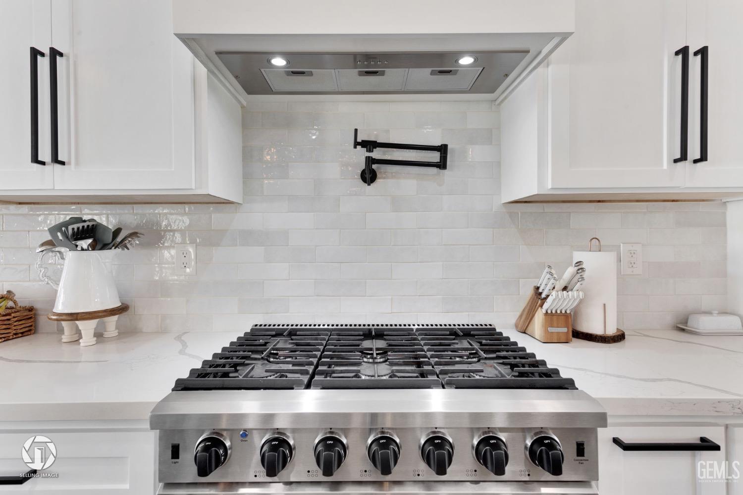 Undisclosed Address Bakersfield, CA 93314 - Photo 21 of 45 a kitchen with a stove and cabinets