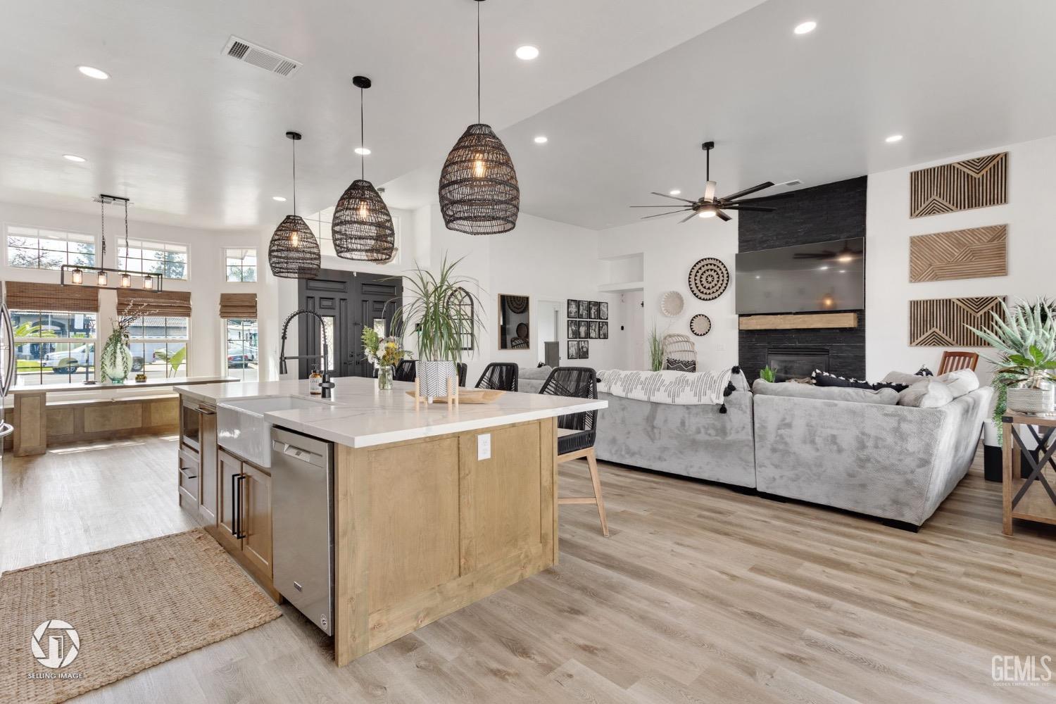 Undisclosed Address Bakersfield, CA 93314 - Photo 22 of 45 a large white kitchen with a large island in the center