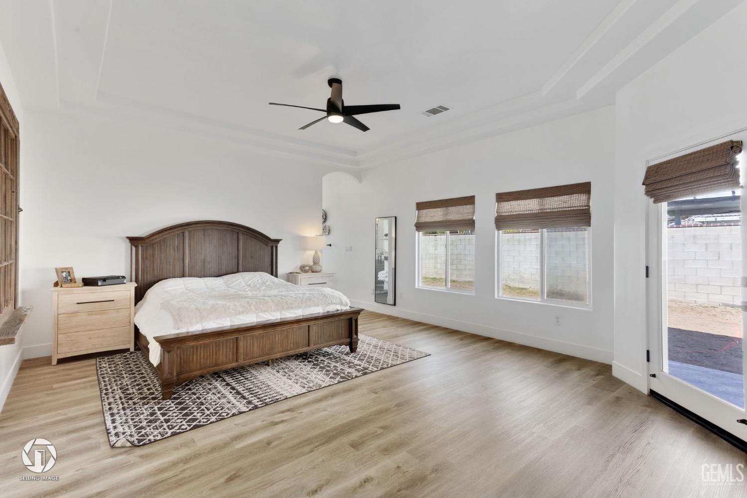 Undisclosed Address Bakersfield, CA 93314 - Photo 27 of 45 a bedroom with a bed and wooden floor