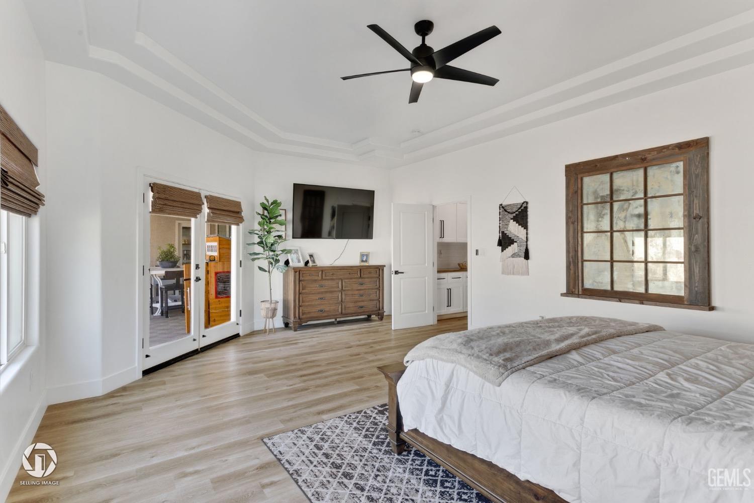 Undisclosed Address Bakersfield, CA 93314 - Photo 29 of 45 a spacious bedroom with a large bed a flat tv screen and a dresser