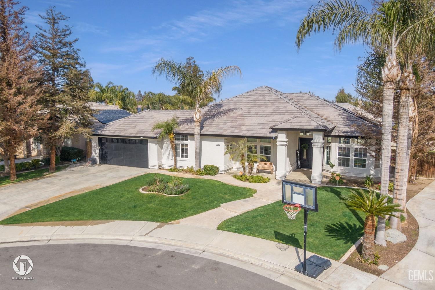 Undisclosed Address Bakersfield, CA 93314 - Photo 3 of 45 a front view of a house with a yard and potted plants