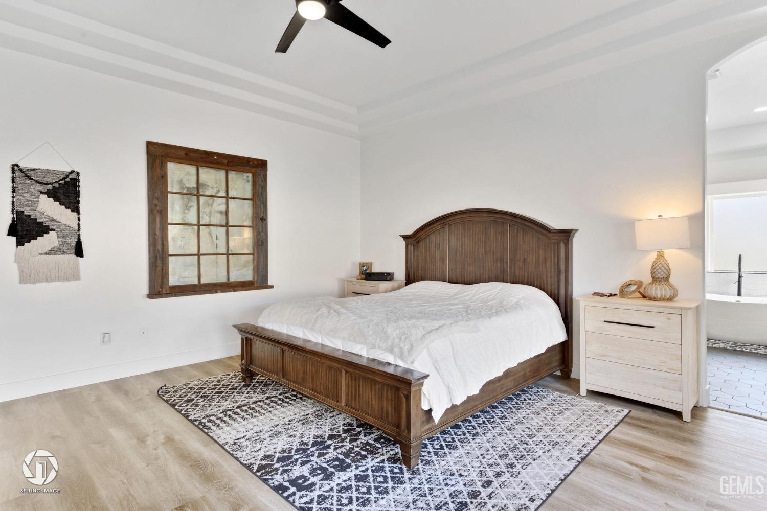 Undisclosed Address Bakersfield, CA 93314 - Photo 31 of 45 a bedroom with a bed and wooden floor