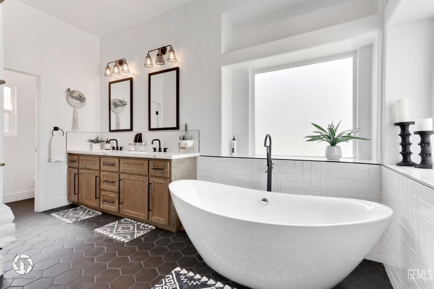 Undisclosed Address Bakersfield, CA 93314 - Photo 32 of 45 a spacious bathroom with a sink and a bathtub