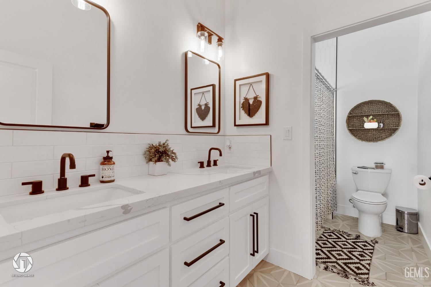 Undisclosed Address Bakersfield, CA 93314 - Photo 37 of 45 a bathroom with a sink a toilet and a mirror