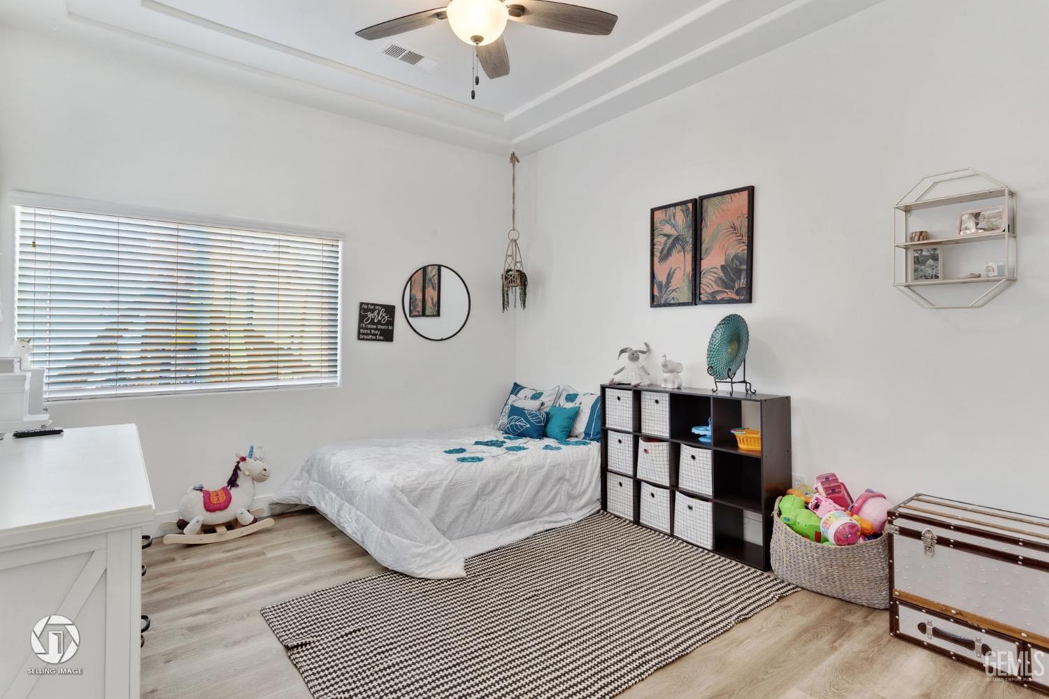 Undisclosed Address Bakersfield, CA 93314 - Photo 39 of 45 a bedroom with a bed and wooden floor