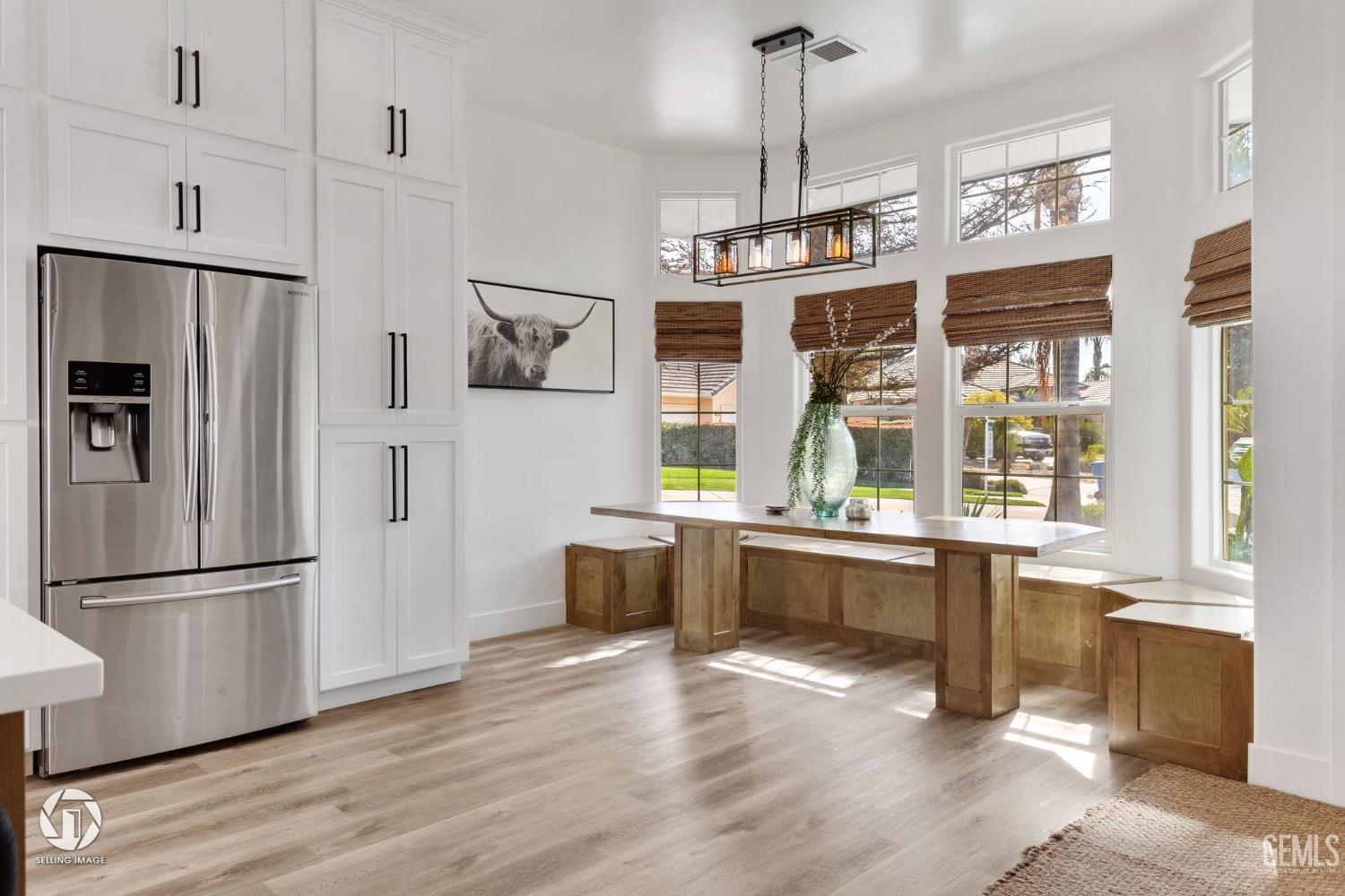 Undisclosed Address Bakersfield, CA 93314 - Photo 8 of 45 a kitchen with stainless steel appliances granite countertop a refrigerator a sink dishwasher a stove and white cabinets with wooden floor