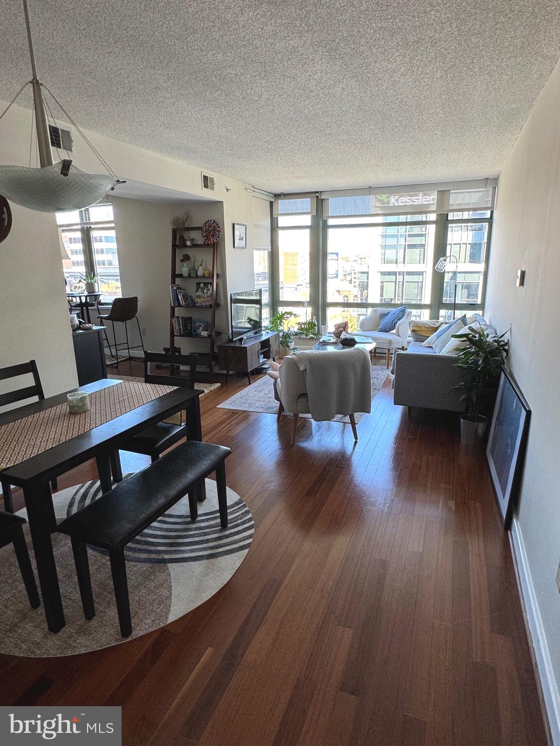 1150 K Street Northwest, Unit 1305 Washington, DC 20005 - Photo 12 of 18 a living room with furniture and wooden floor