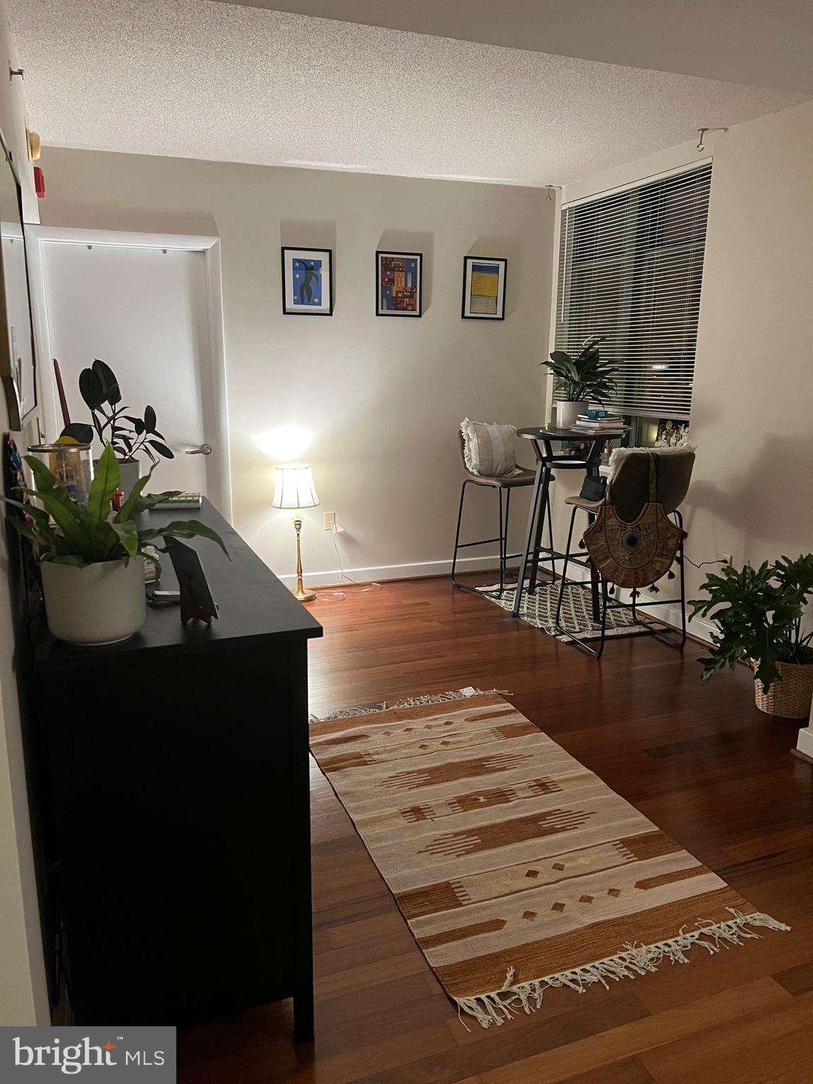 1150 K Street Northwest, Unit 1305 Washington, DC 20005 - Photo 14 of 18 a living room with furniture and a wooden floor