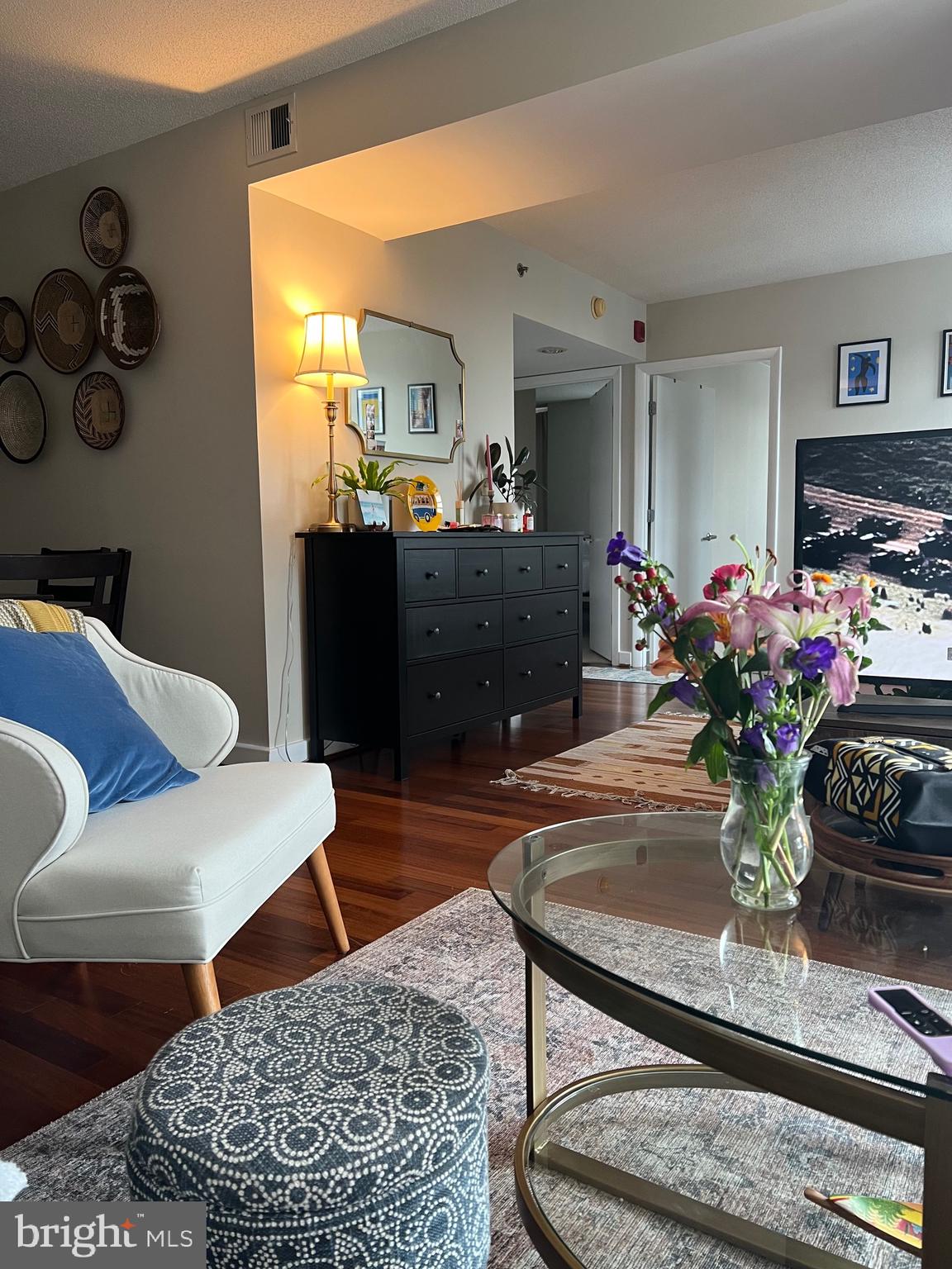 1150 K Street Northwest, Unit 1305 Washington, DC 20005 - Photo 15 of 18 a living room with furniture and flowers