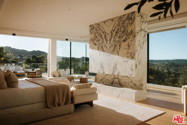 a bedroom with a bed couch and window