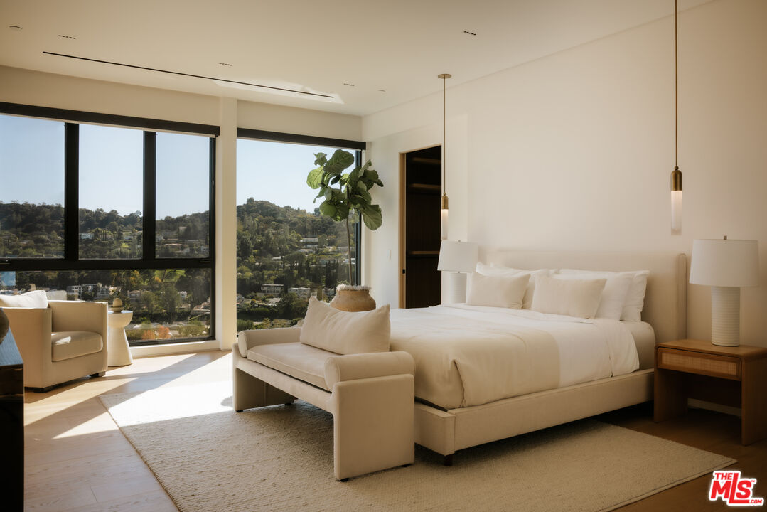 16187 Royal Oak Road Encino, CA 91436 - Photo 20 of 40 a bedroom with a bed and large window