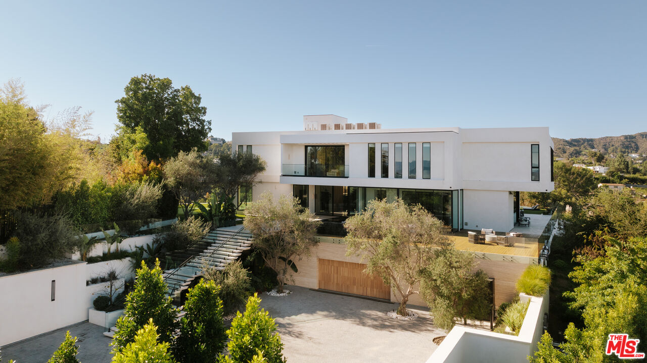 16187 Royal Oak Road Encino, CA 91436 - Photo 2 of 40 a front view of a house with a yard