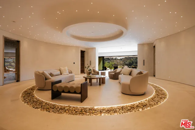 a living room with furniture and a potted plant