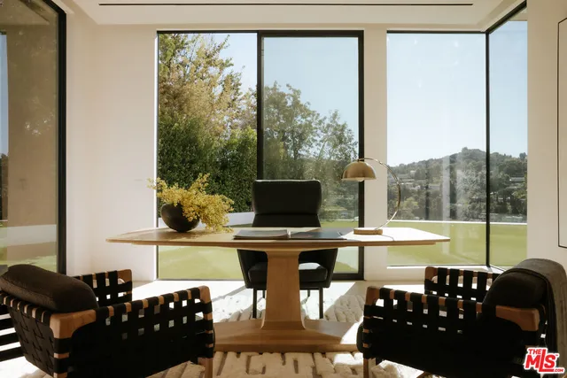 a dining room with furniture a large window and a chandelier