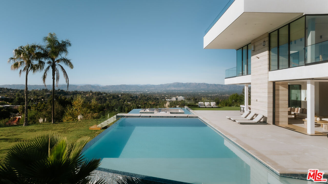 16187 Royal Oak Road Encino, CA 91436 - Photo 3 of 40 a view of a swimming pool with a patio