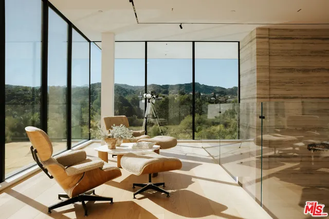 a room with gym equipment and glass door shower