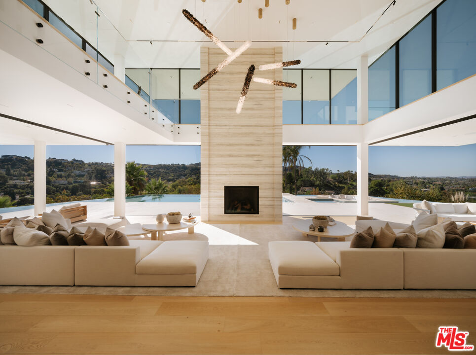 16187 Royal Oak Road Encino, CA 91436 - Photo 5 of 40 a view of a patio with couches and a fireplace