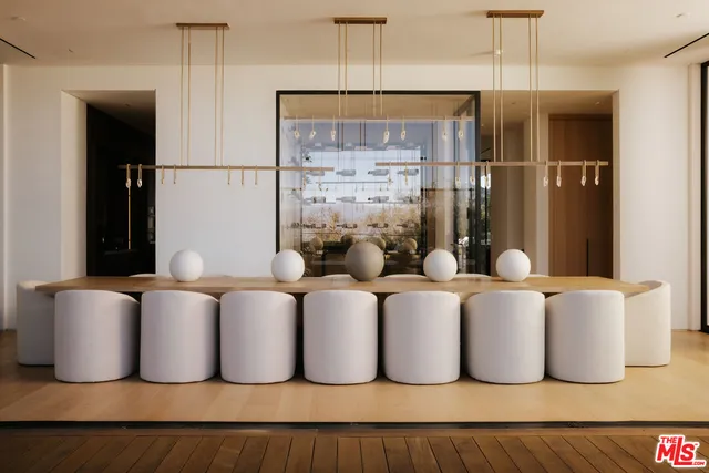 a living room with large glass windows and furniture