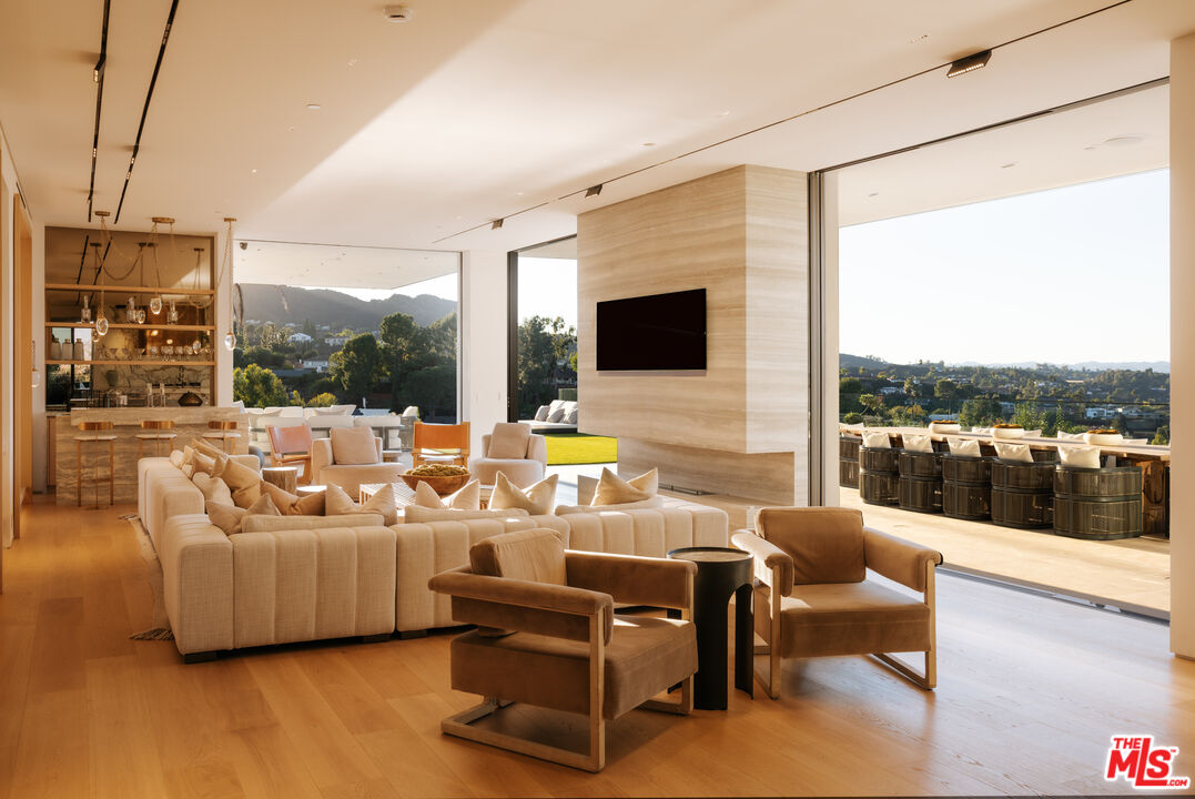 16187 Royal Oak Road Encino, CA 91436 - Photo 9 of 40 a outdoor space with patio the couches and a flat screen tv