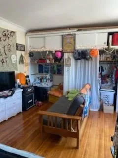 a living room filled with furniture and a wooden floor