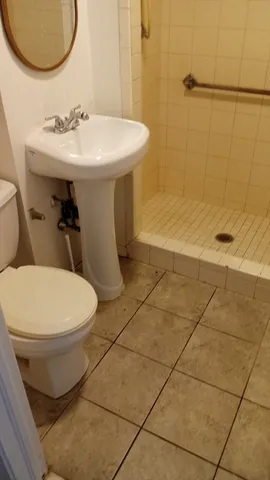 a bathroom with a sink toilet and a mirror
