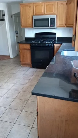 a kitchen with granite countertop a stove and a cabinets