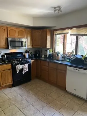 a kitchen with a sink a stove and cabinets