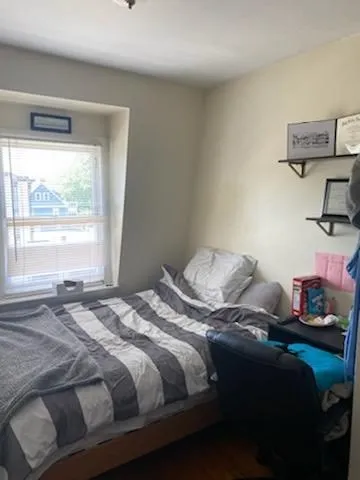 a bedroom with a bed and a window