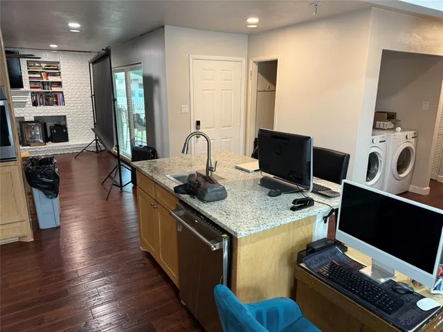 a kitchen with stainless steel appliances granite countertop a stove and a refrigerator