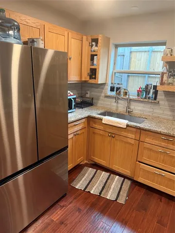 a kitchen with stainless steel appliances a refrigerator sink and cabinets