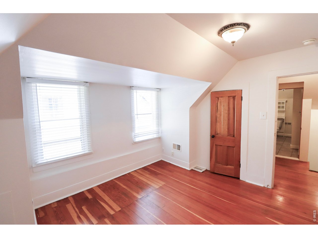 608 South Howes Street Fort Collins, CO 80521 - Photo 22 of 28 a view of an empty room with wooden floor and a window