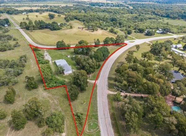an aerial view of a swimming pool with a yard