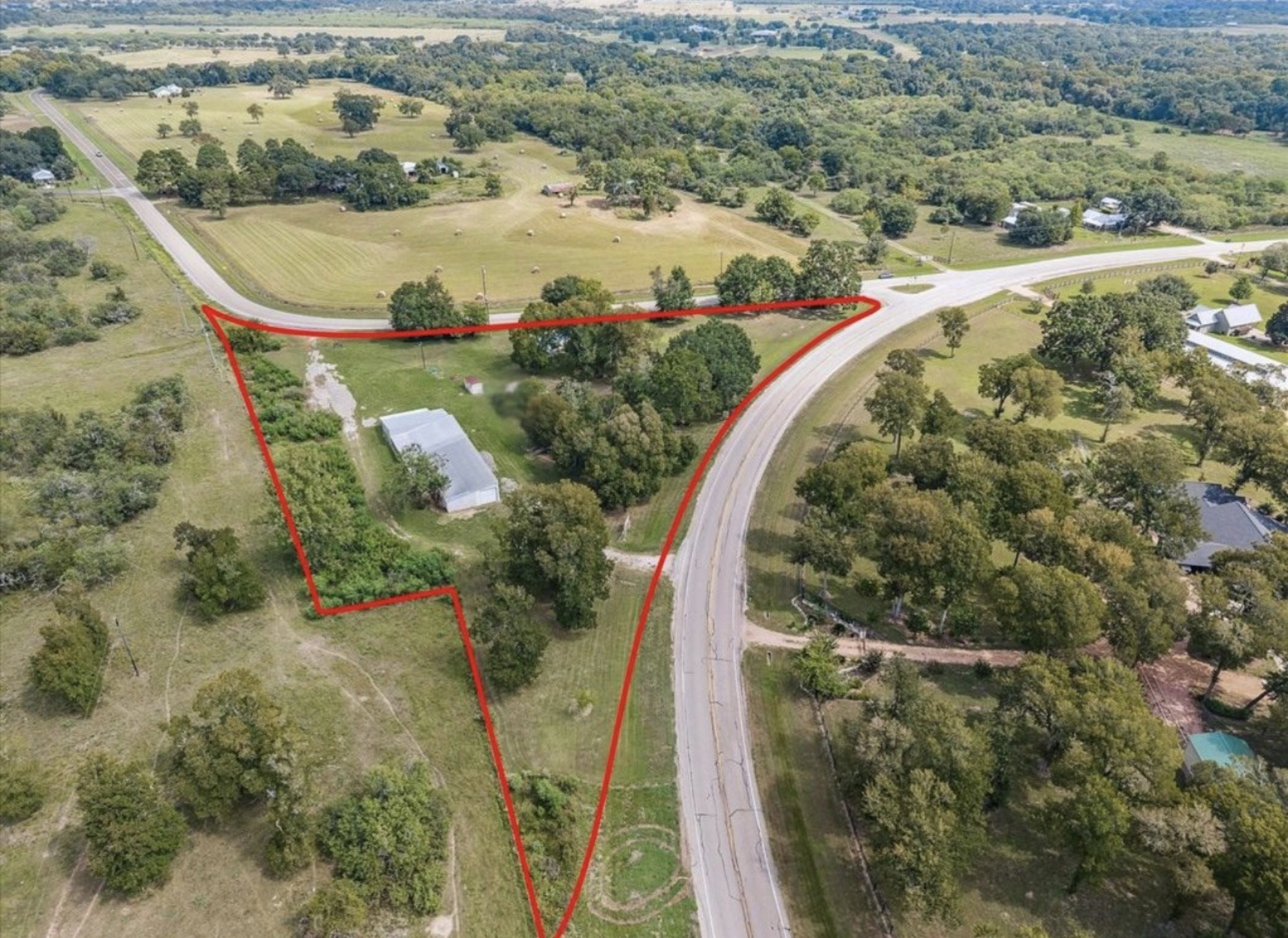 an aerial view of a swimming pool with a yard