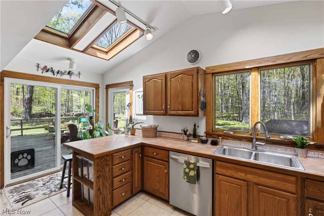31599 Fairview Road Chagrin Falls, OH 44022 - Photo 18 of 50 The Kitchen has two skylights in its high ceiling. The glass slider provides quick and easy access to the deck and back garden
