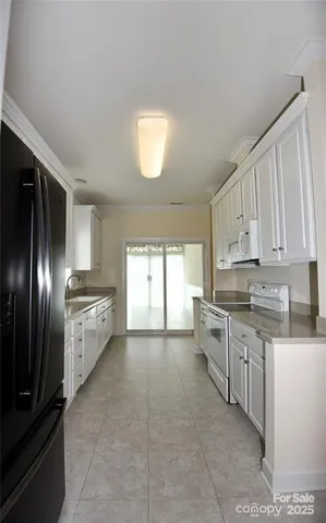 a large kitchen with cabinets and stainless steel appliances