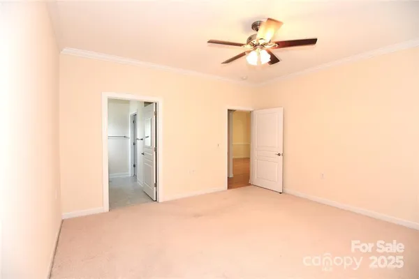 a view of a room with a ceiling fan and closet