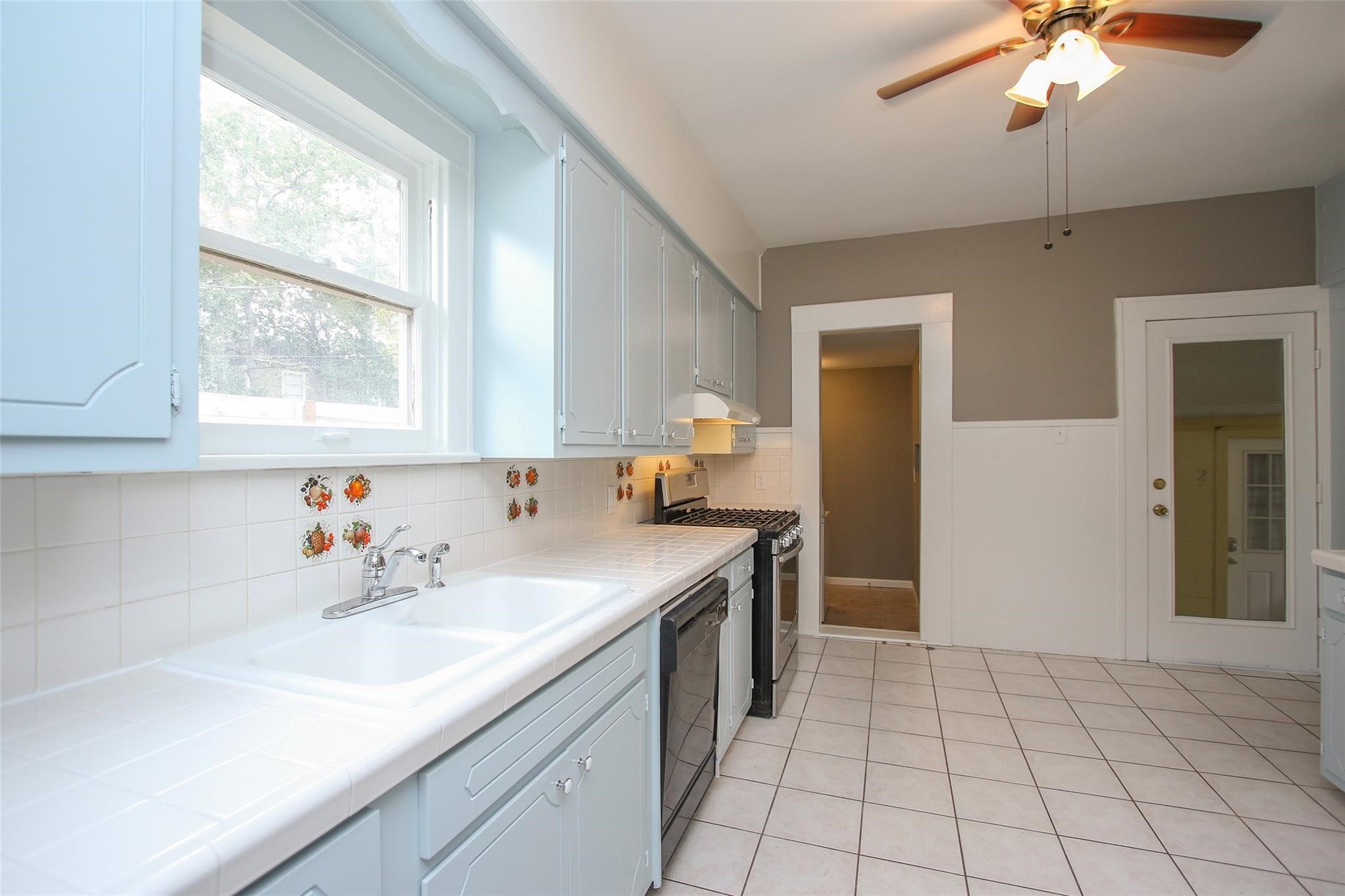 1127 Walling Street Houston, TX 77009 - Photo 8 of 23 a kitchen with a sink cabinets and window