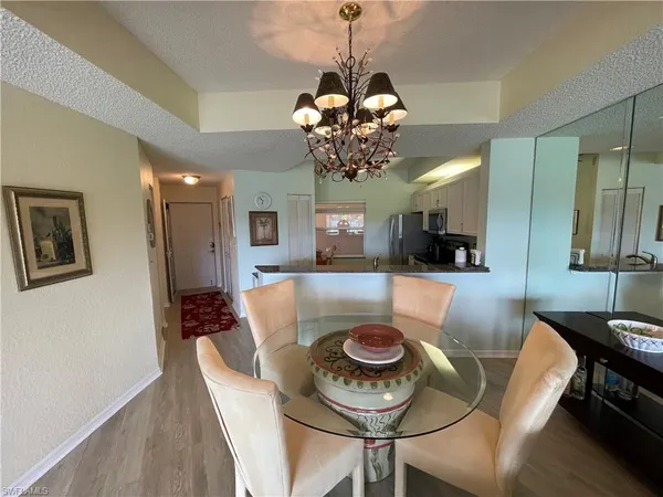a view of a dining room with furniture and a chandelier