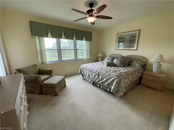 a bedroom with a bed couch and window