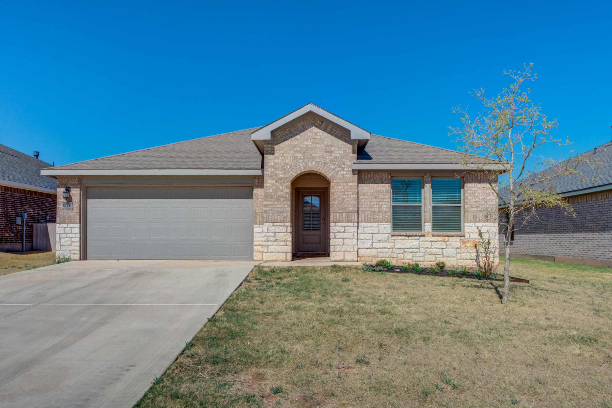 10506 Bangor Avenue Lubbock, TX 79424 - Photo 1 of 37 a front view of a house with a yard and garage