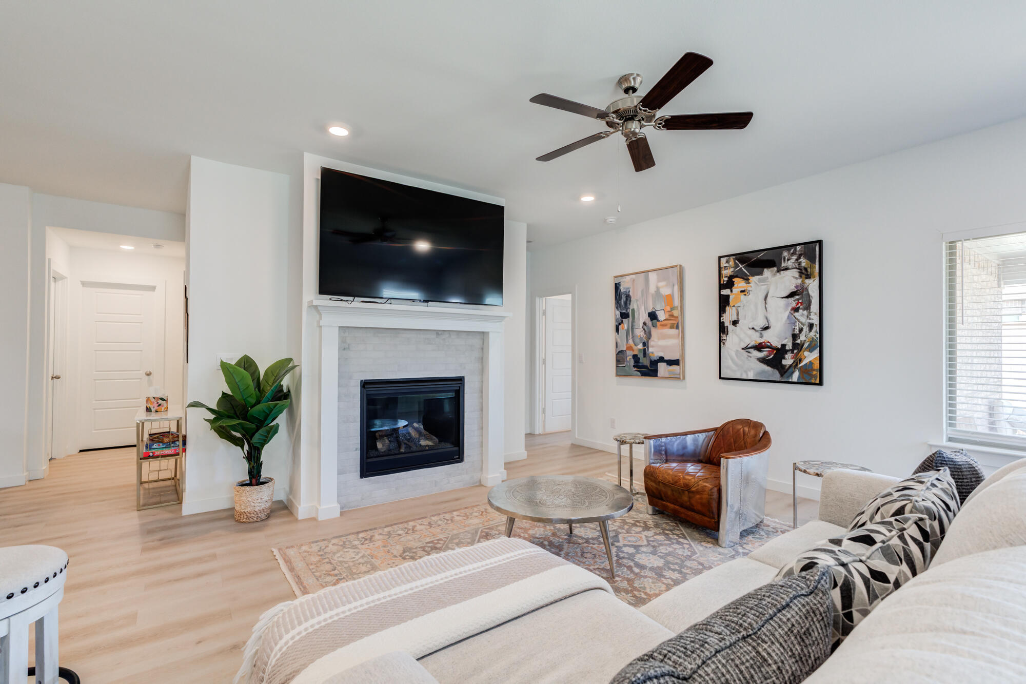 10506 Bangor Avenue Lubbock, TX 79424 - Photo 24 of 37 a living room with furniture a flat screen tv and a fireplace