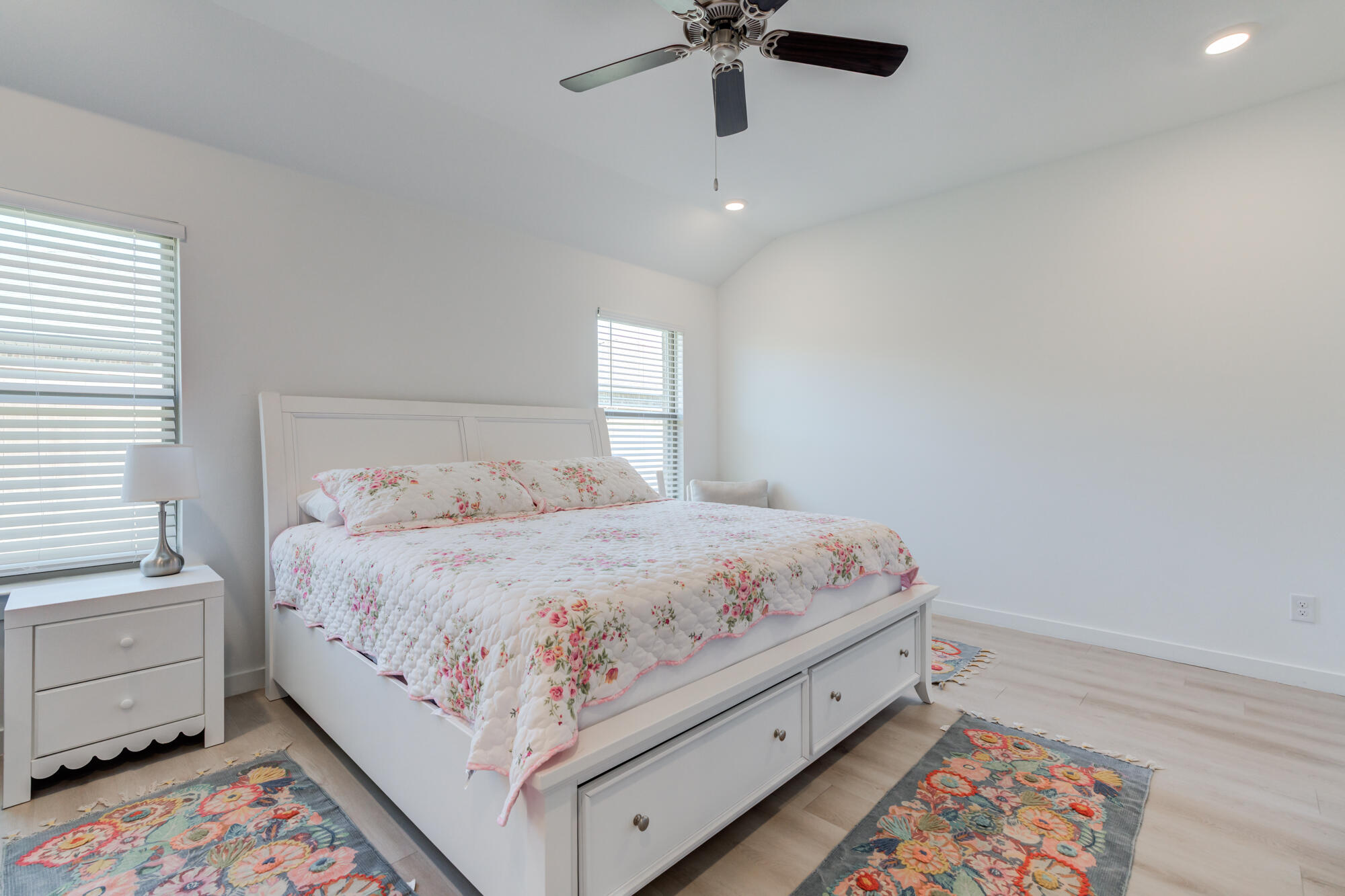 10506 Bangor Avenue Lubbock, TX 79424 - Photo 26 of 37 a bedroom with a bed and a chandelier