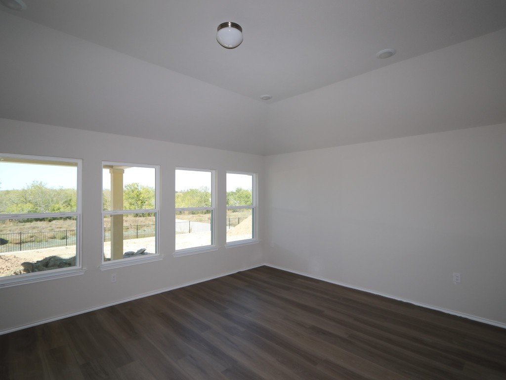 9204 Furman Drive Austin, TX 78747 - Photo 3 of 17 a view of an empty room with wooden floor and a window