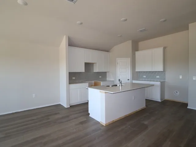 a kitchen with a sink and cabinets