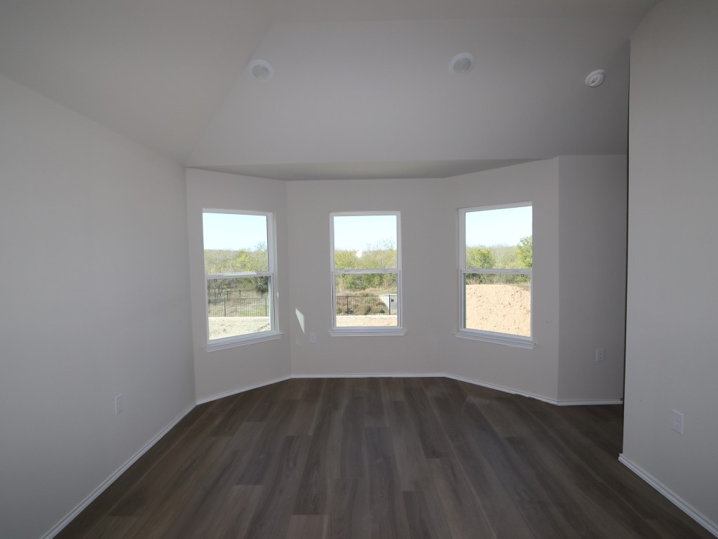 9204 Furman Drive Austin, TX 78747 - Photo 10 of 17 an empty room with wooden floor and windows