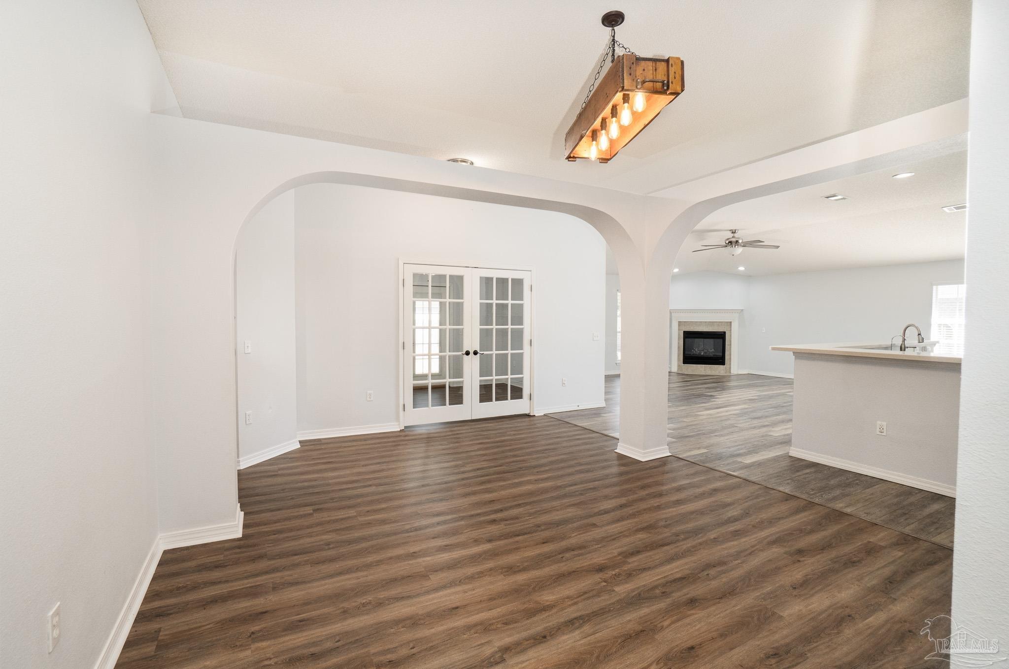 4836 Timber Ridge Drive Pace, FL 32571 - Photo 12 of 46 a view of empty room with wooden floor and fan