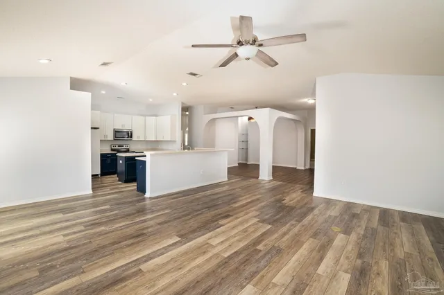 a view of a kitchen with a stove cabinets and wooden floor