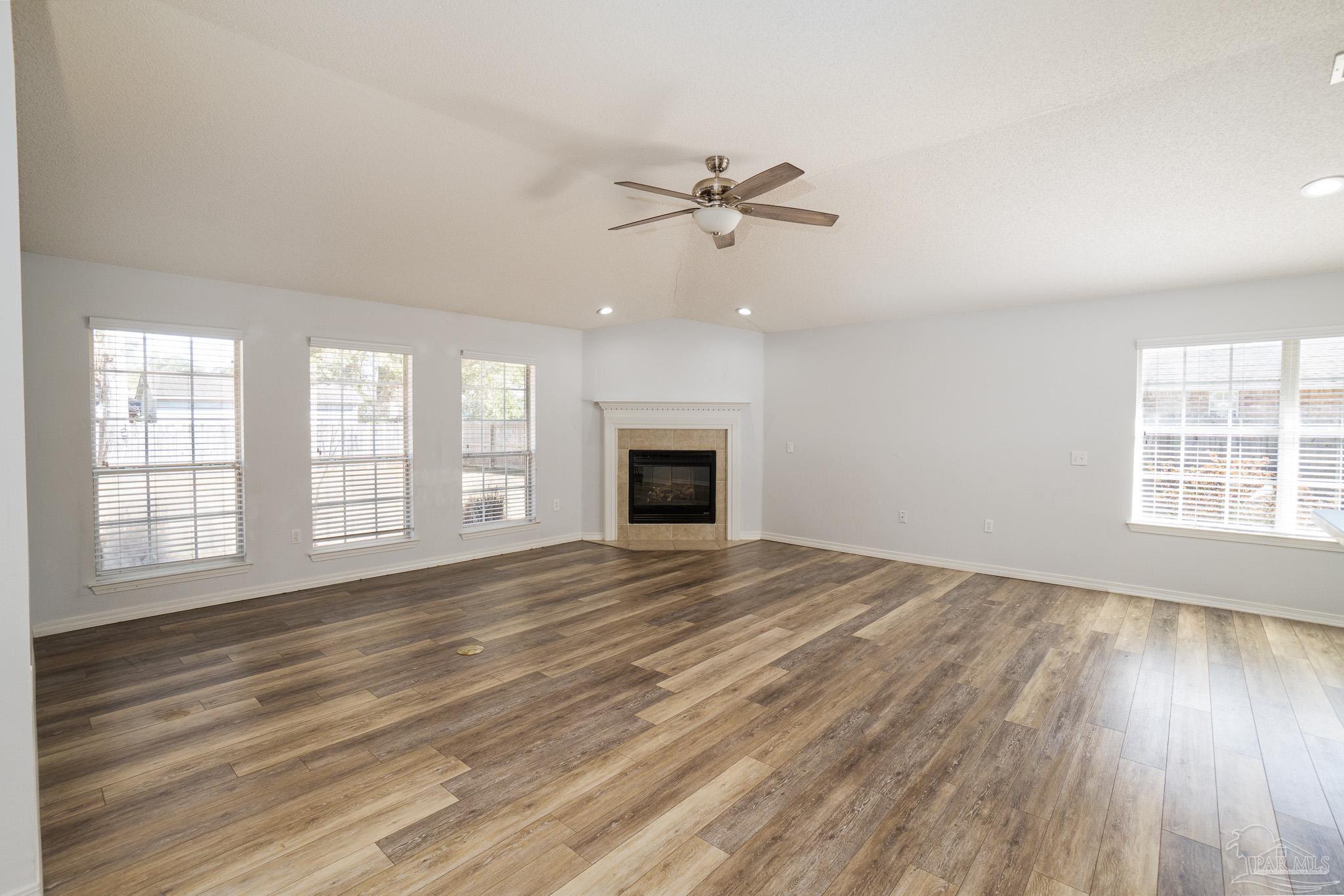 4836 Timber Ridge Drive Pace, FL 32571 - Photo 14 of 46 a view of an empty room with a window and wooden floor