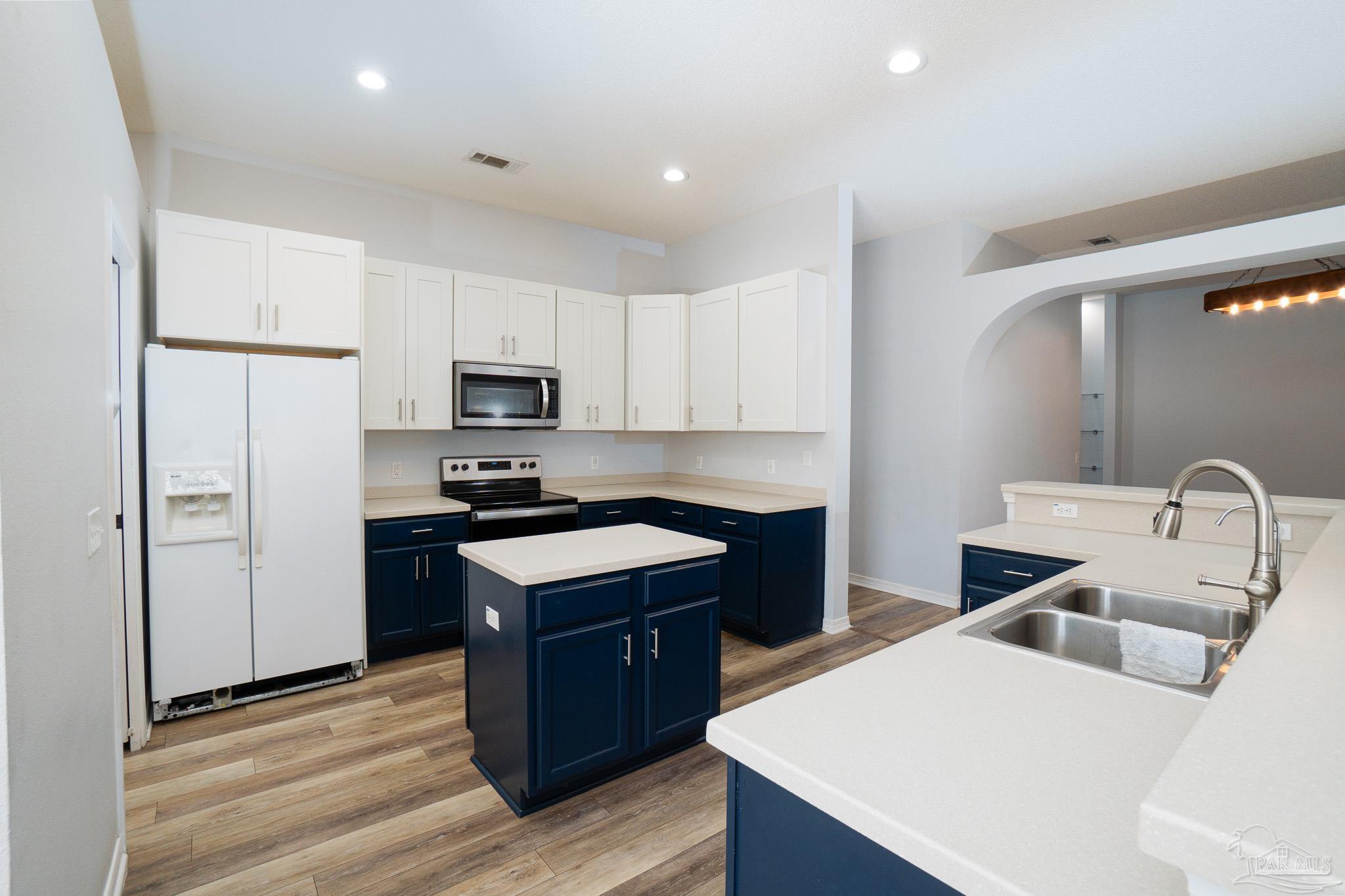 4836 Timber Ridge Drive Pace, FL 32571 - Photo 15 of 46 a kitchen with a sink a stove a refrigerator cabinets and a counter top space